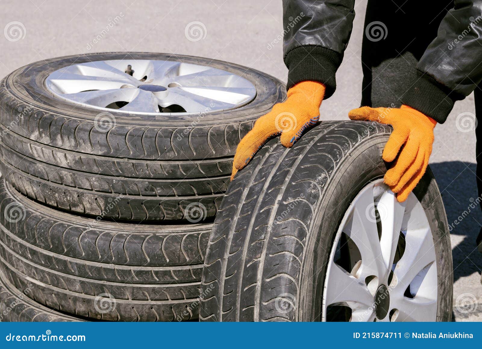 Mechanic With Orange Gloves Is Using Chalk To Mark Tires While Leaning On  One In His Workshop Stock Photo - Download Image Now - iStock