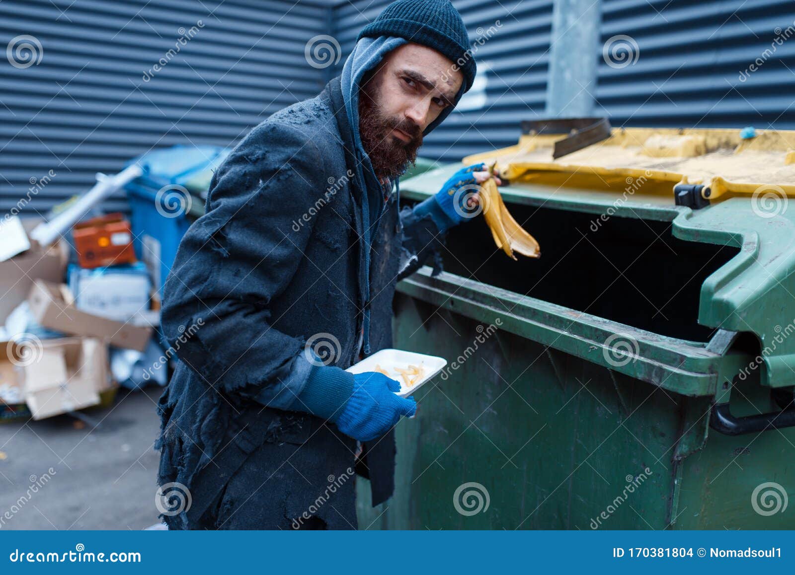 Male Bearded Beggar Searching Food In Trashcan Stock Photo - Image of