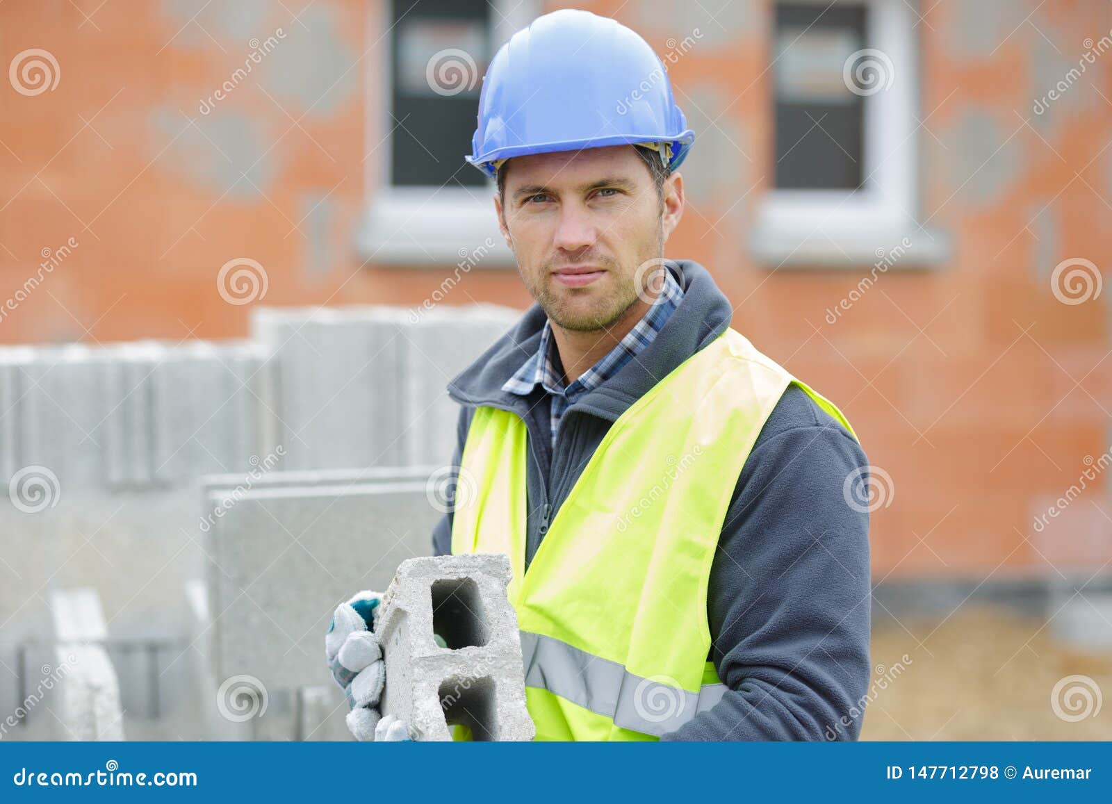 male builder installing concrete blocks