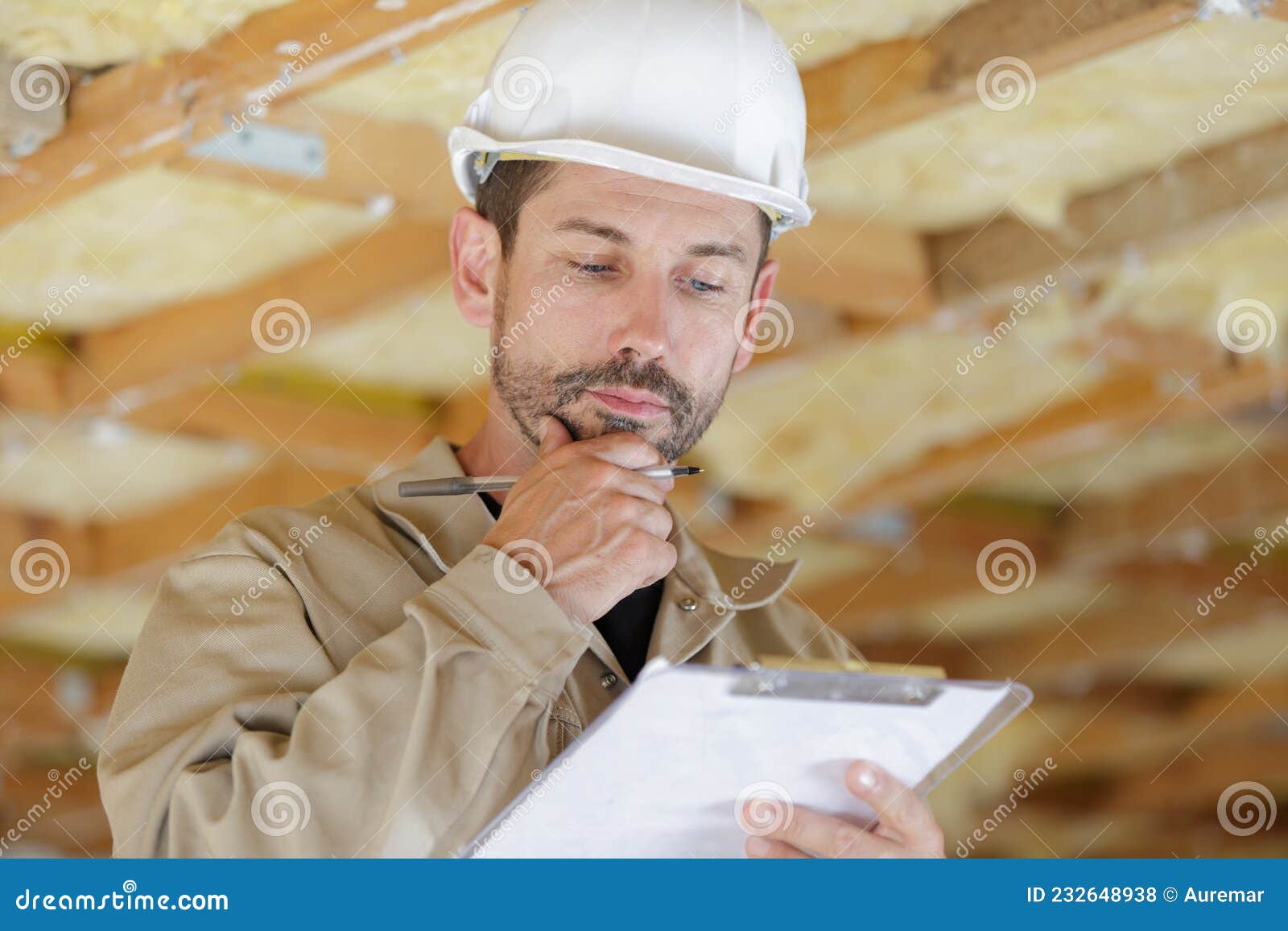 male builder looking at clipboard