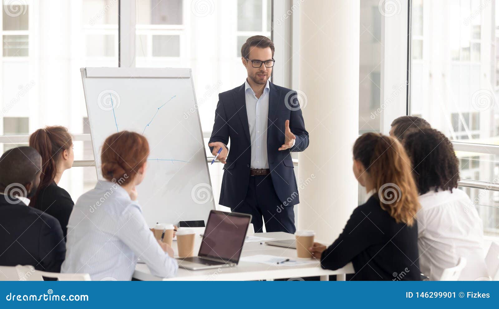 male business coach speaker in suit give flipchart presentation