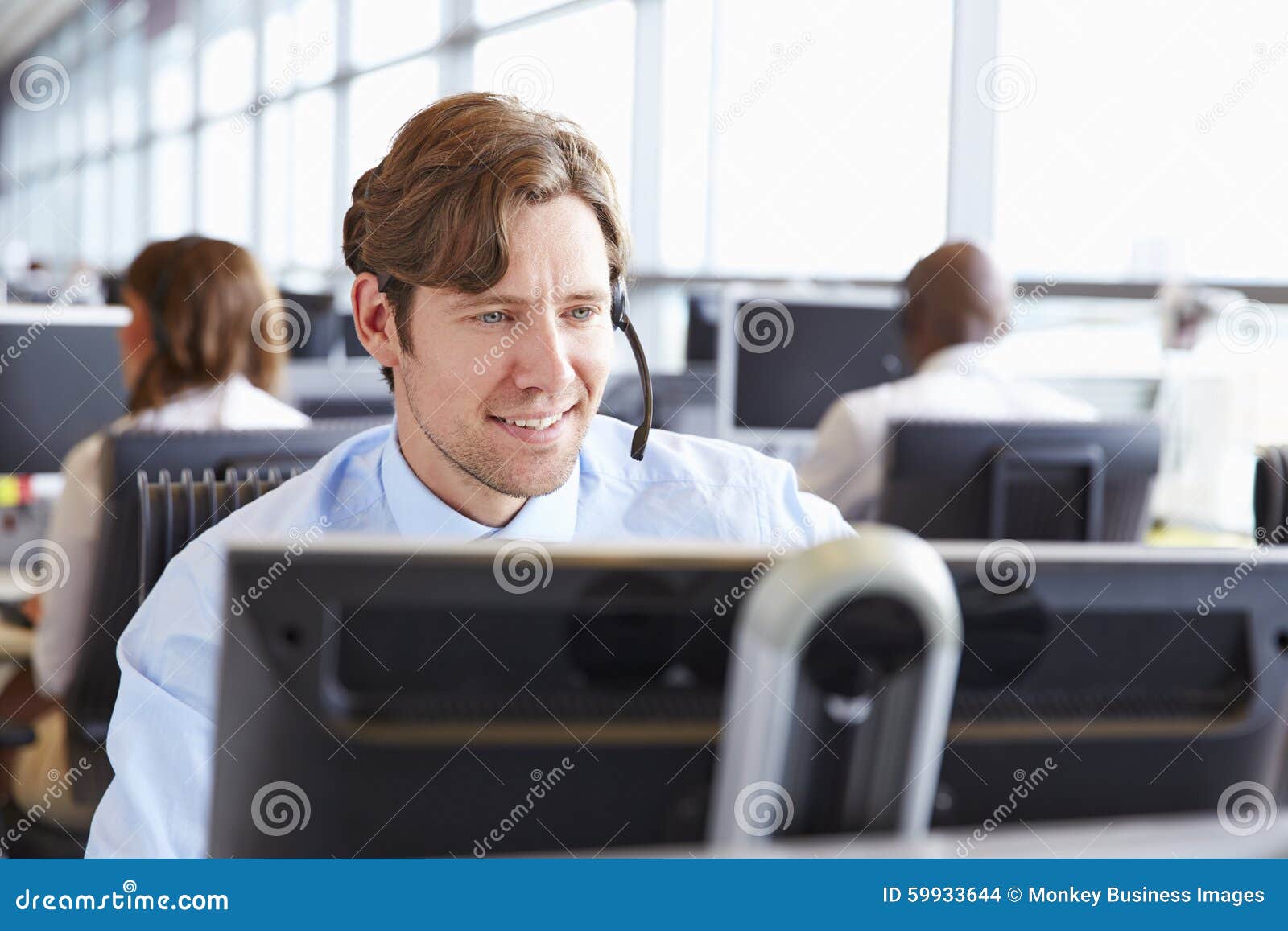 male call centre worker, looking at screen, close-up
