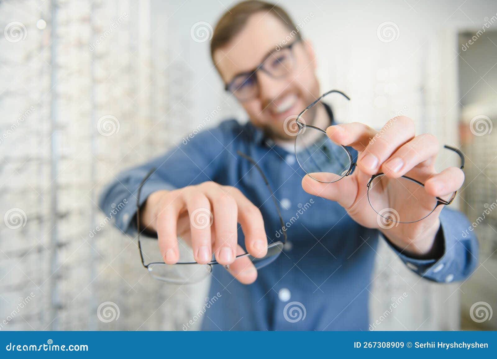Male Client Chooing New Eyeglasses Frame for His New Eyeglasses in ...