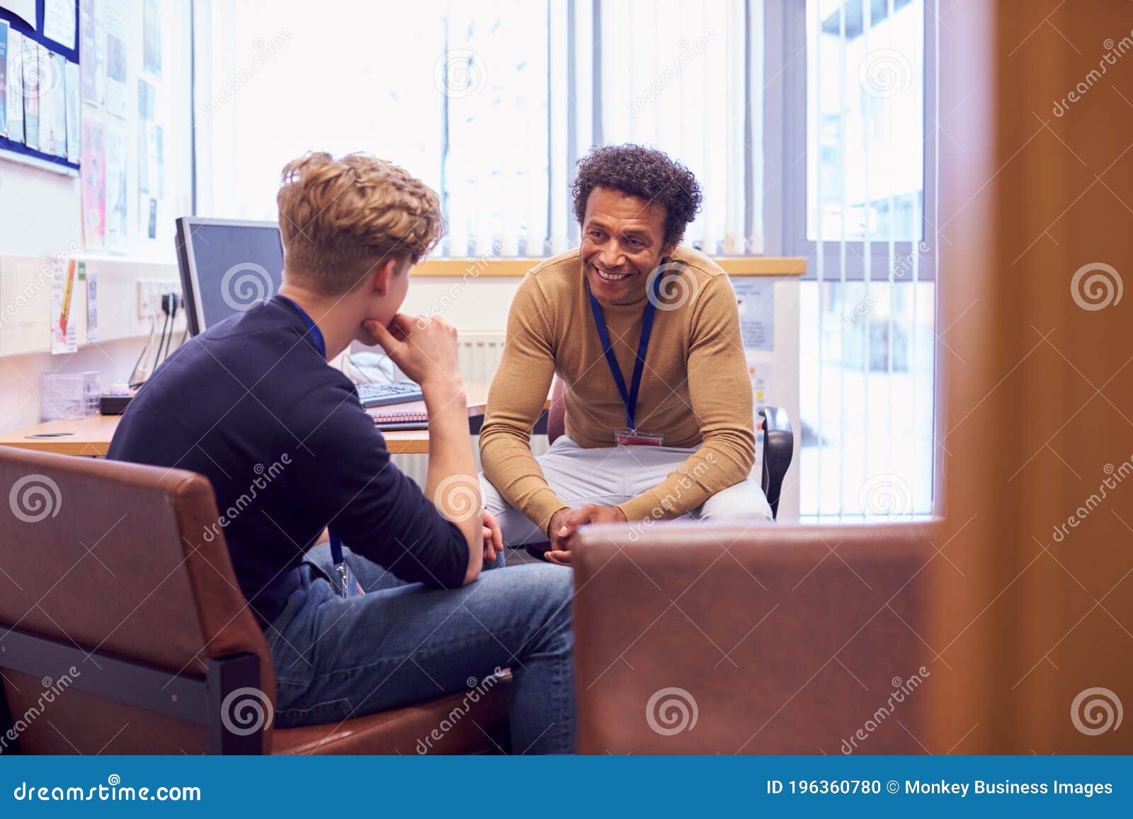 male college student meeting with campus counselor discussing mental health issues