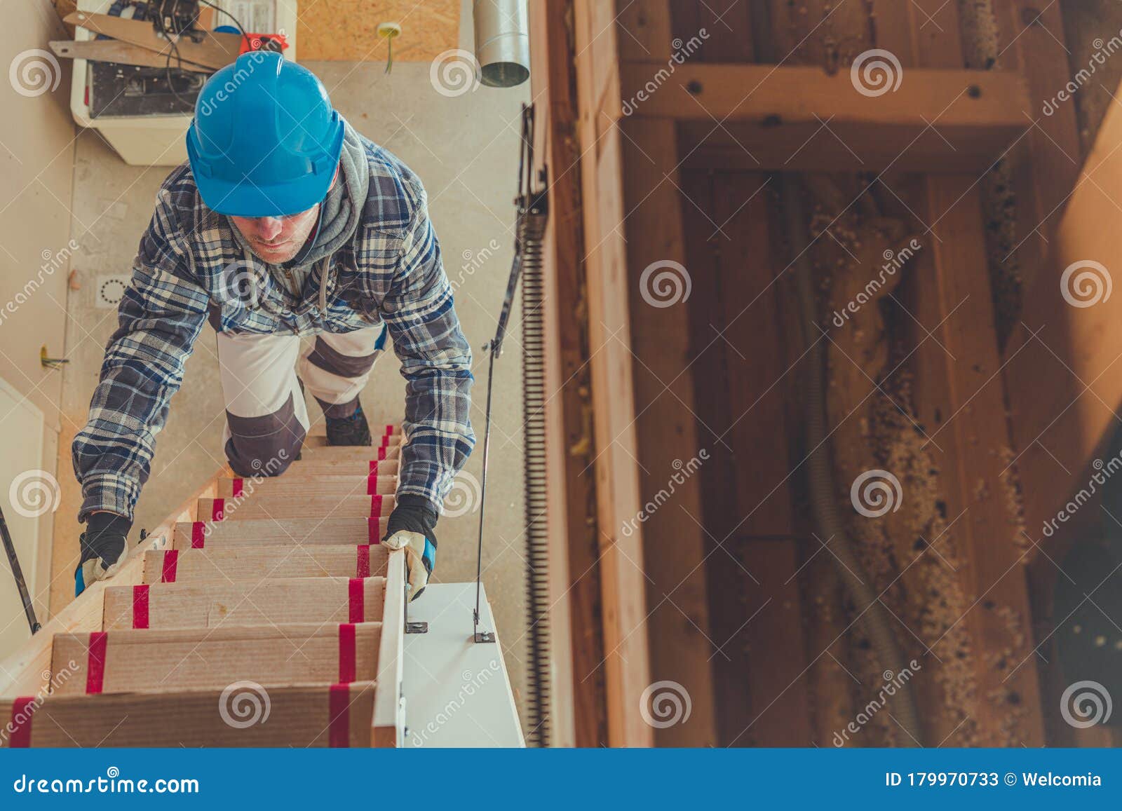male constrcution worker climbing steps to get to second floor of house