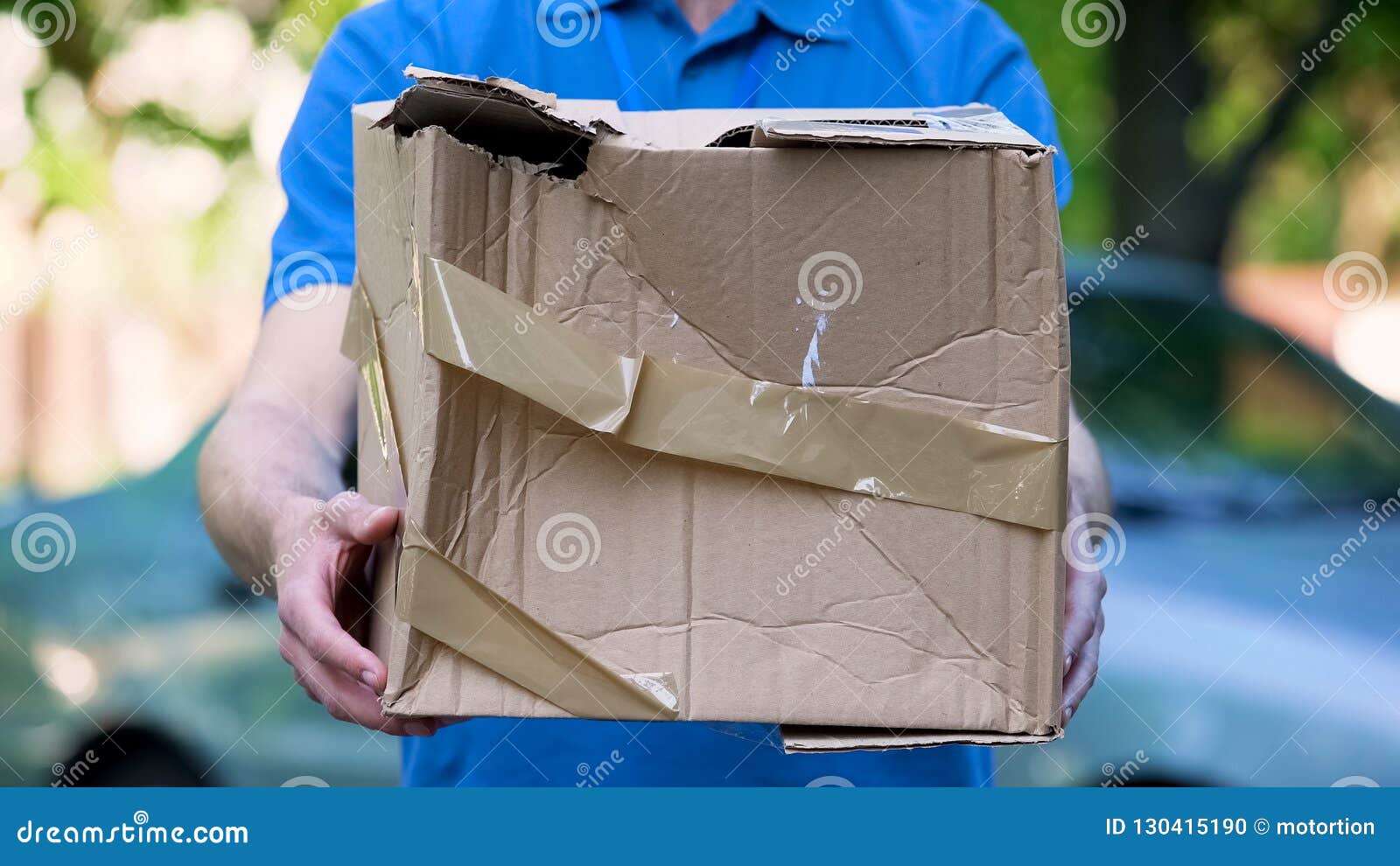 male courier showing damaged box, cheap parcel delivery, poor shipment quality