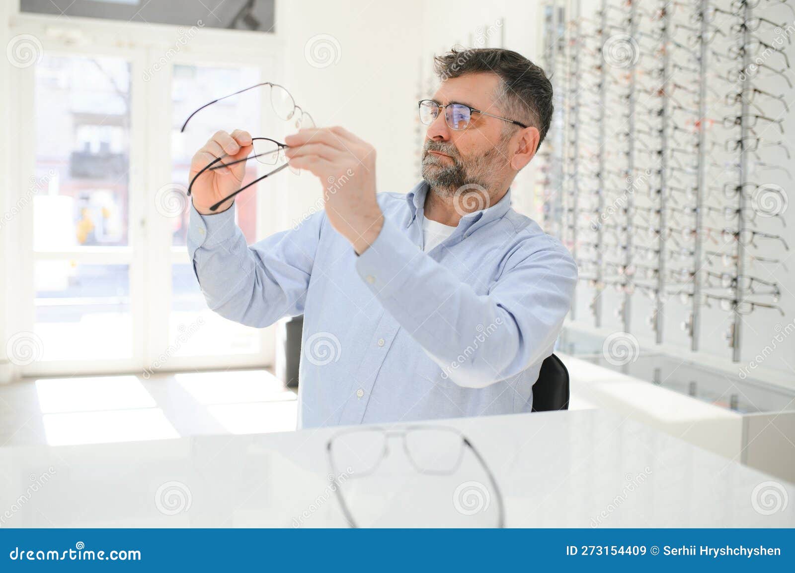 Male Customer Choosing Glasses in Optics Store Stock Image - Image of ...