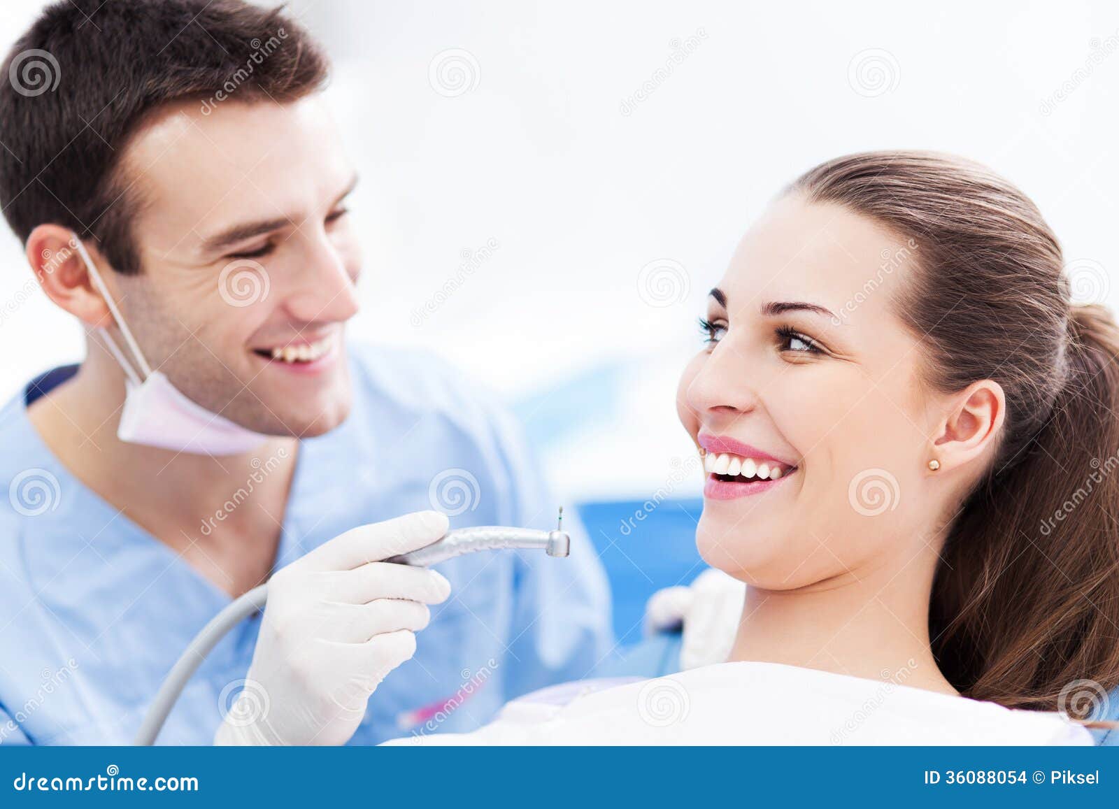 male dentist and woman in dentistÃ¢â¬â¢s office