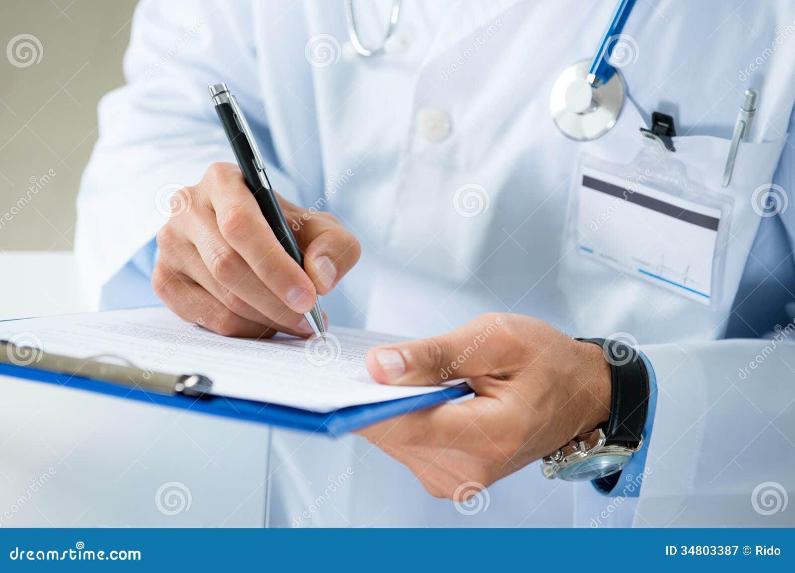 male doctor writing on medical document