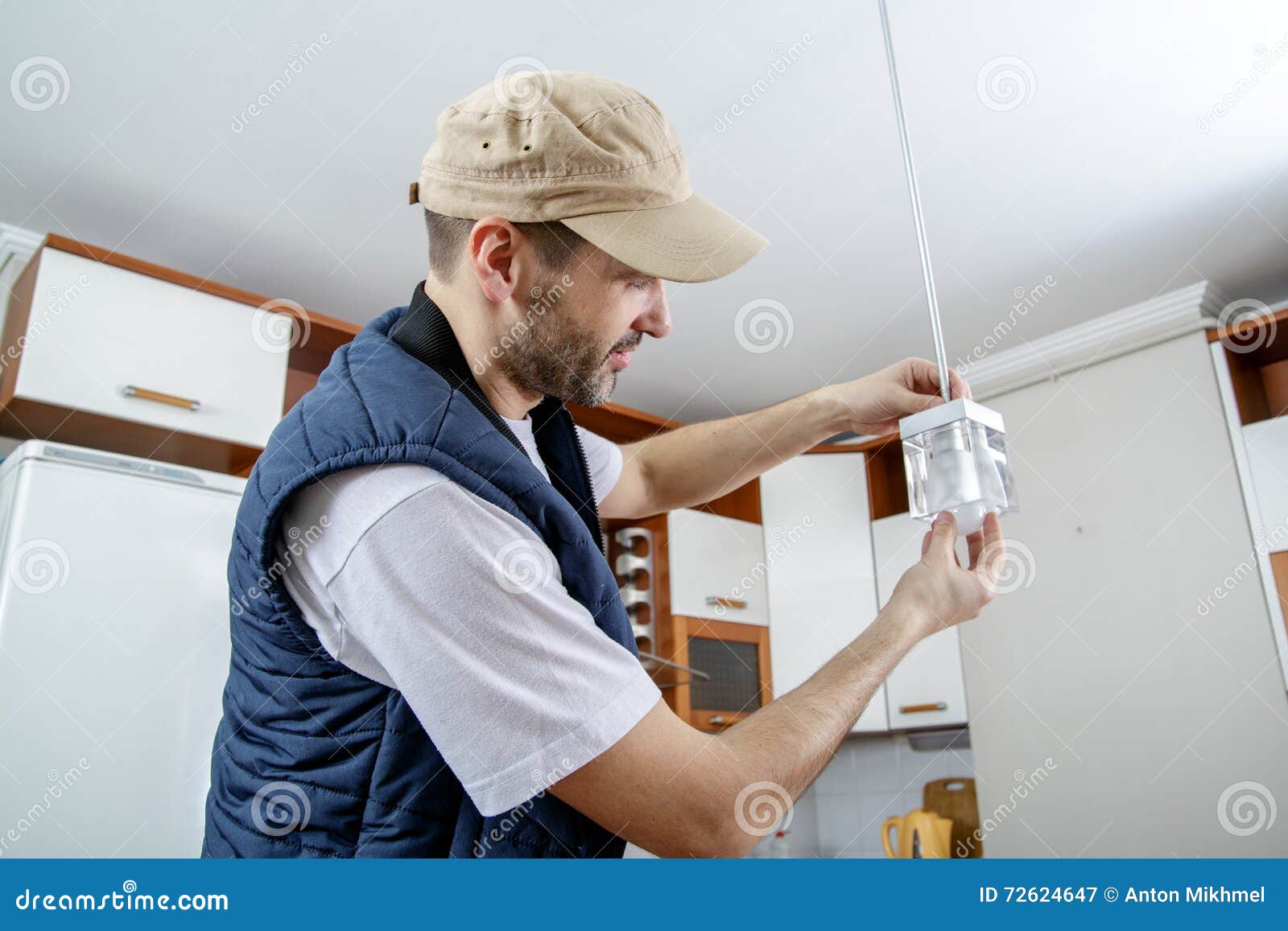 A Male Electrician Fixing Light On The Ceiling Stock Image