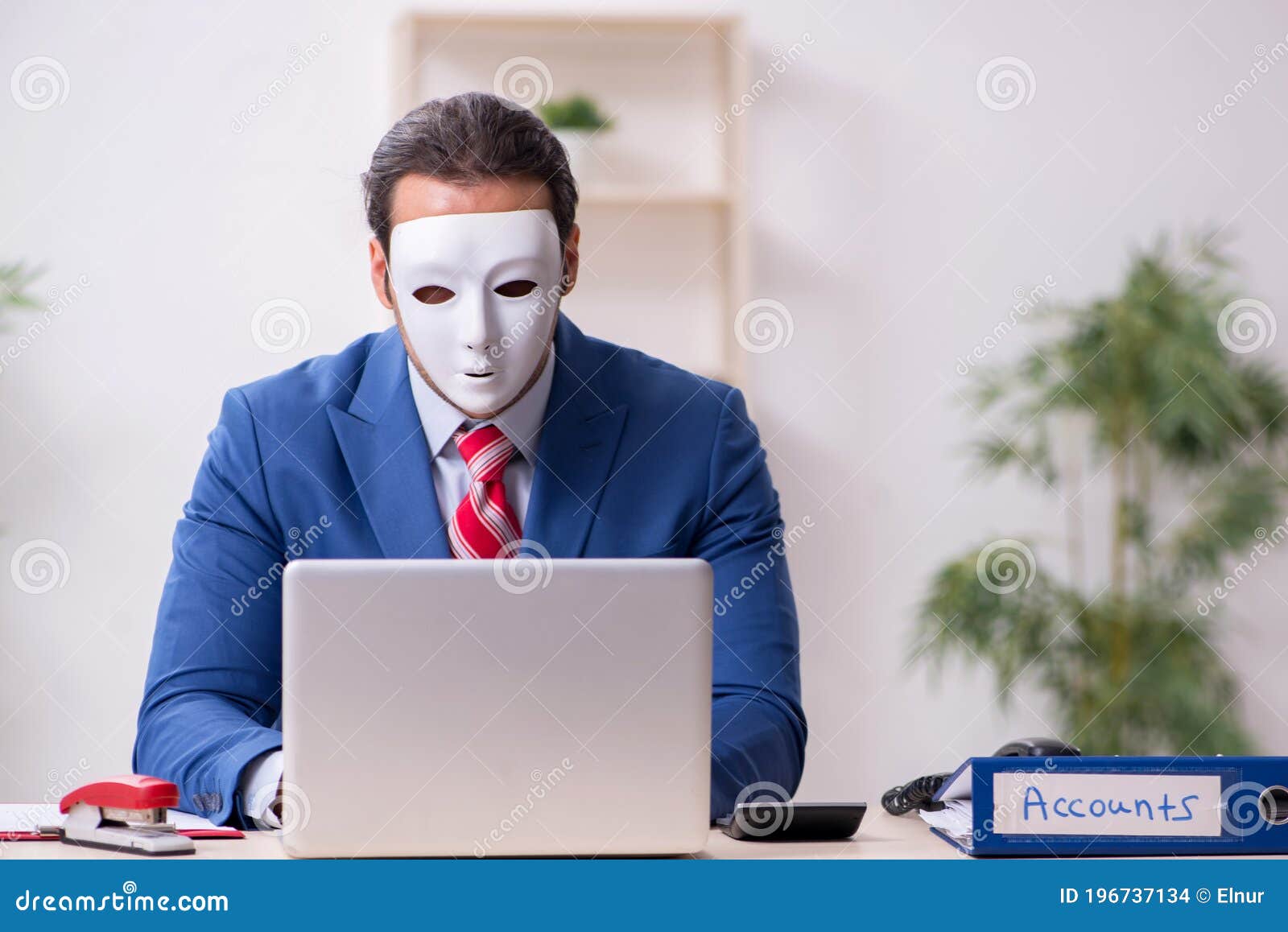 male employee with mask in hipocrisy concept