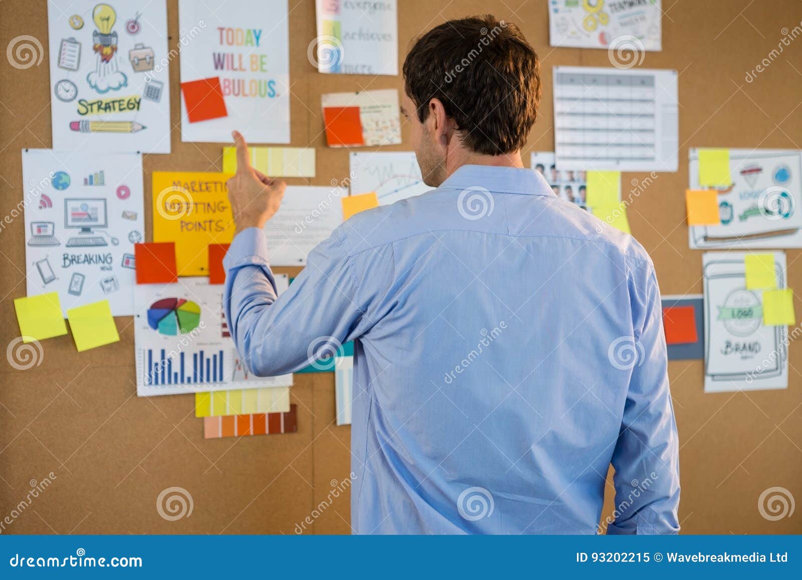 Male Executive Pointing at Bulletin Board in Office Stock Image Image