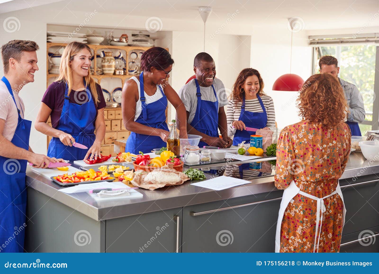 Male and Female Adult Students with Teacher Preparing Ingredients for