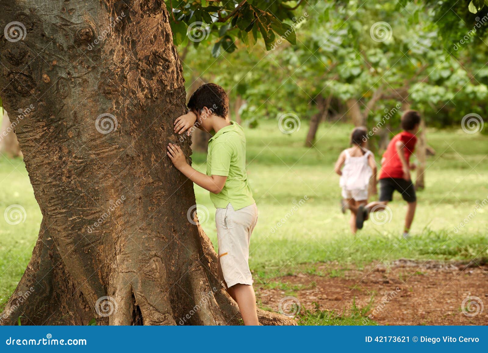 male and female children playing hide and seek