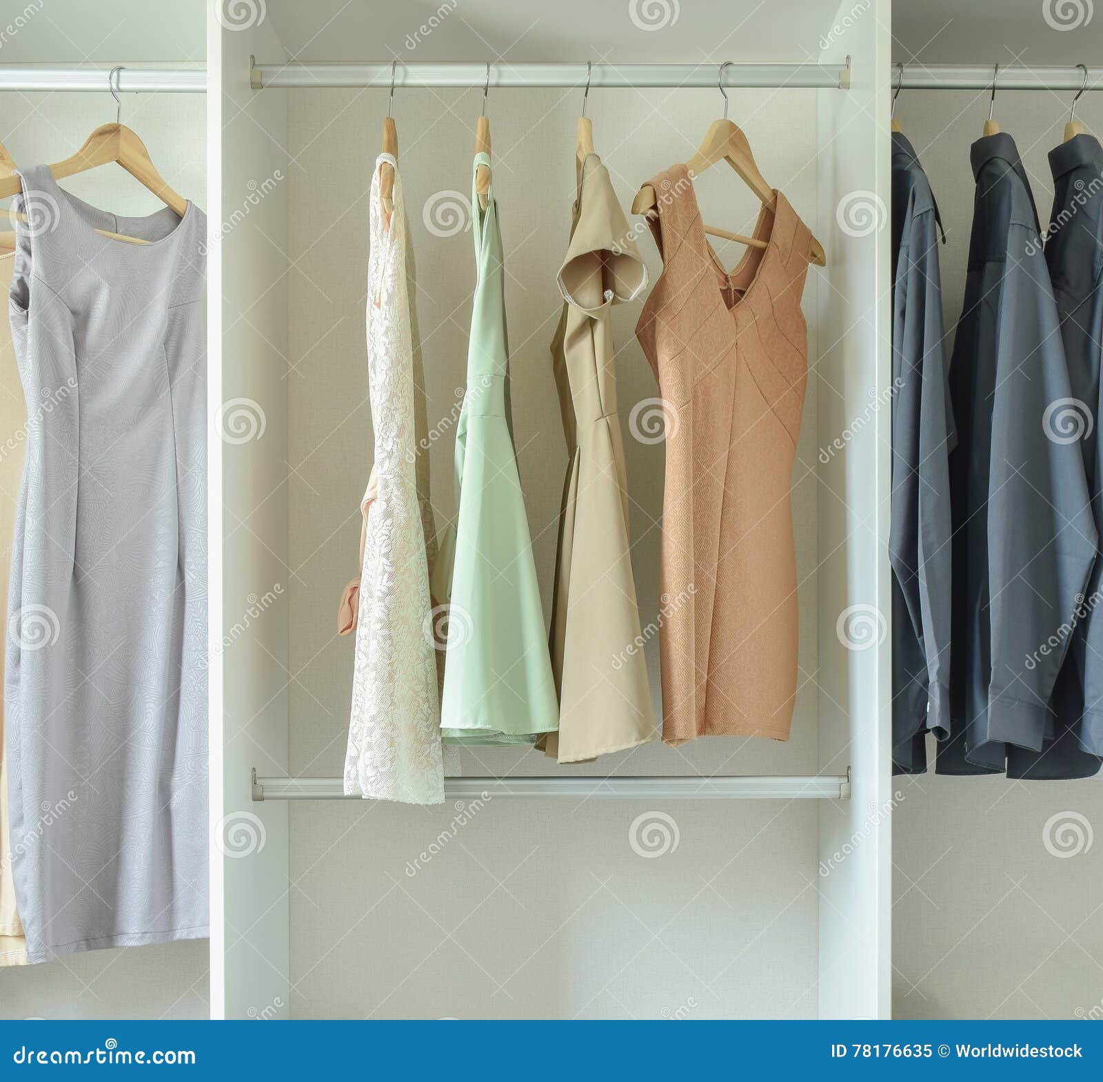 Male and Female Clothes Hanging on Hangers in Wardrobe Stock Image ...