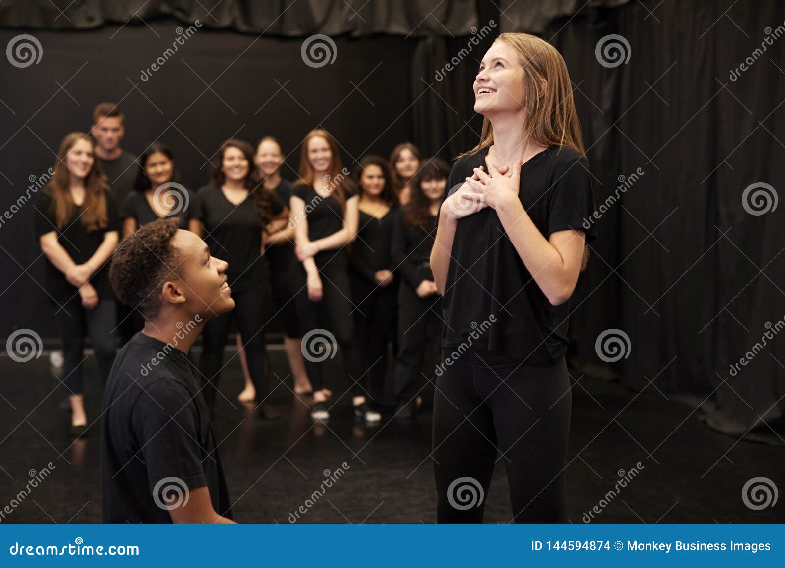 male and female drama students at performing arts school in studio improvisation class