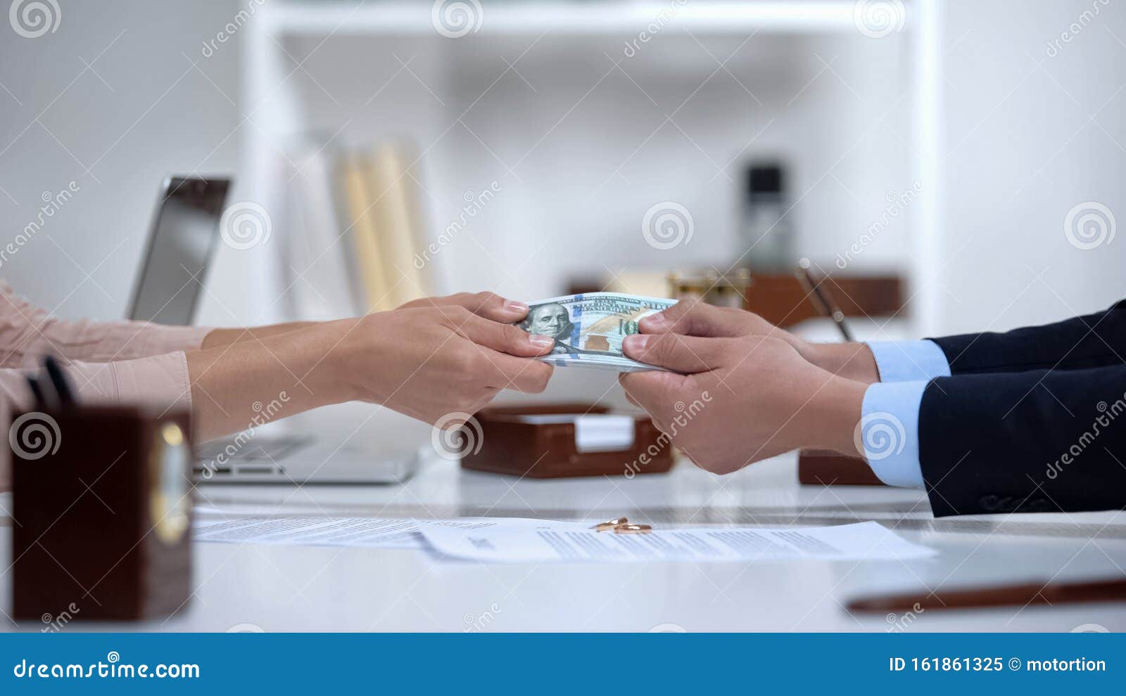 male and female hands pulling money, dividing marital property during divorce