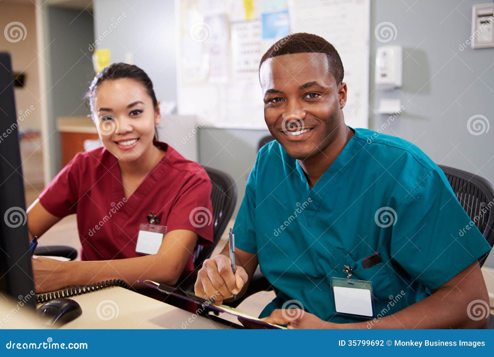male and female nurse working at nurses station