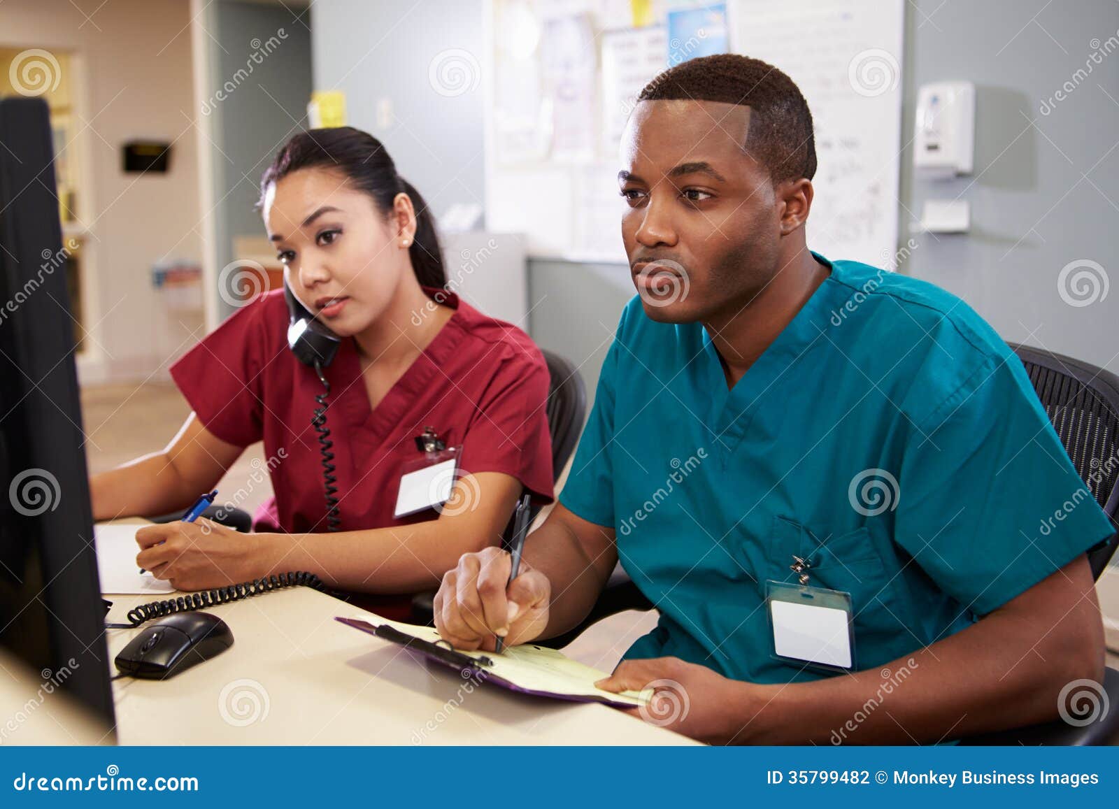 male and female nurse working at nurses station