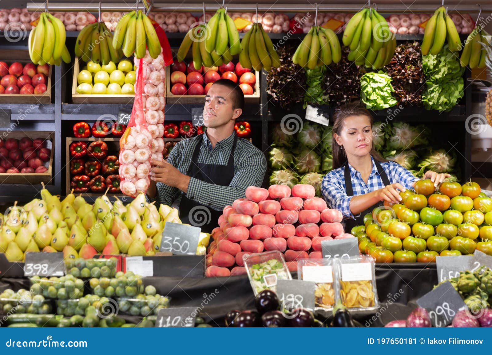 two sellers laying out vegetables