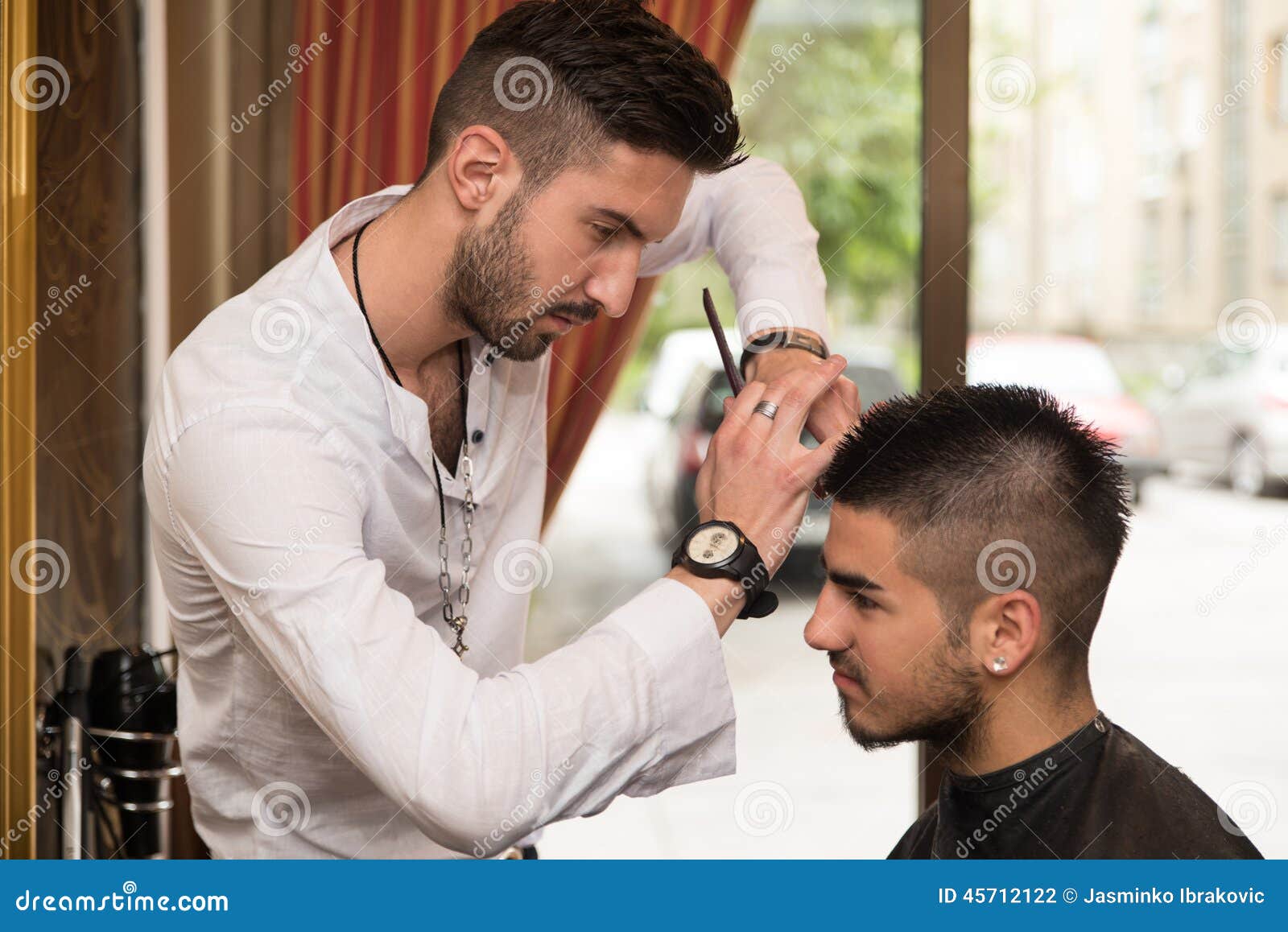 Male Hairdresser Cutting Hair Of Smiling Man Client Stock 