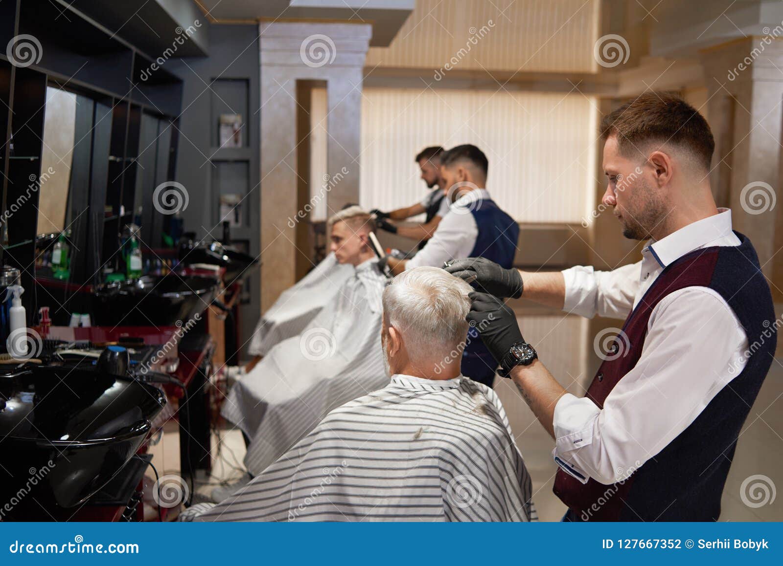 Male Hairdressers Grooming Client S Haircuts In Barbershop Stock