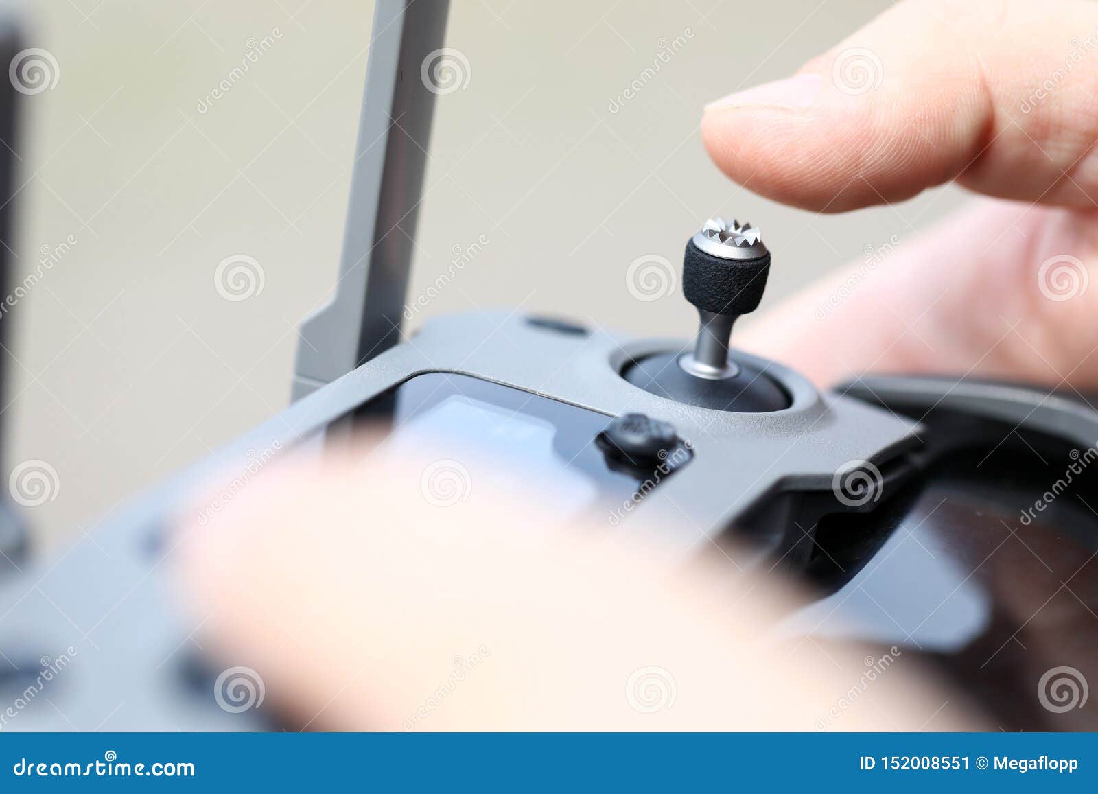 Male Hand Holding Modern Flying Drone Remote Navigating it with Stick