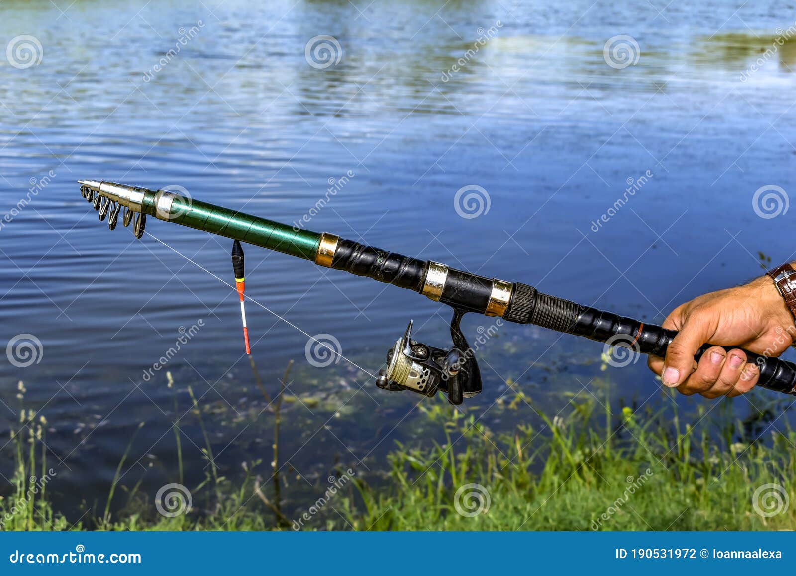 Male Hand Holds Spinning on the Background of Muddy Freshwater of a Lake,  River or Pond. Folding Fishing Rod on Blue Stock Photo - Image of  caucasian, hand: 190531972