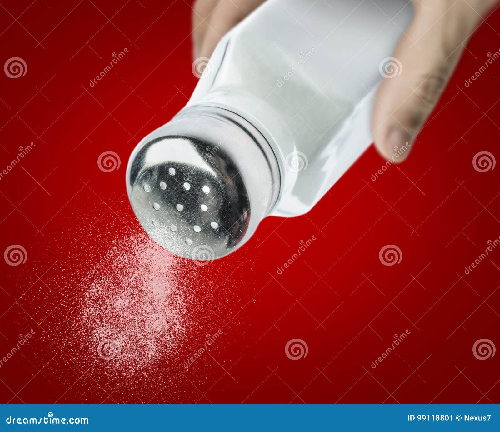 male hand pouring salt from a salt shaker