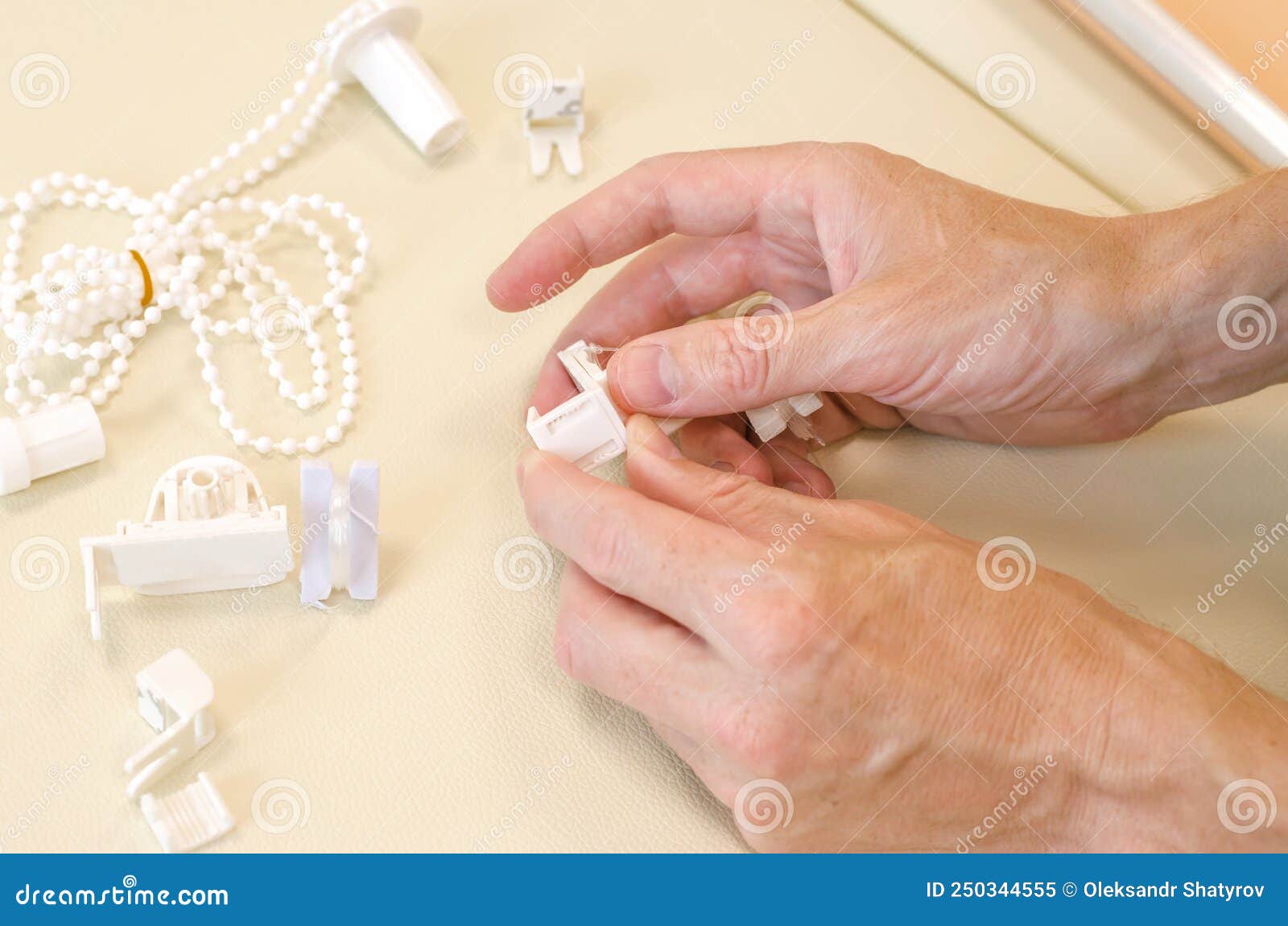 Male Hands are Assembling Roller Blinds. Assembly of Roller Blinds