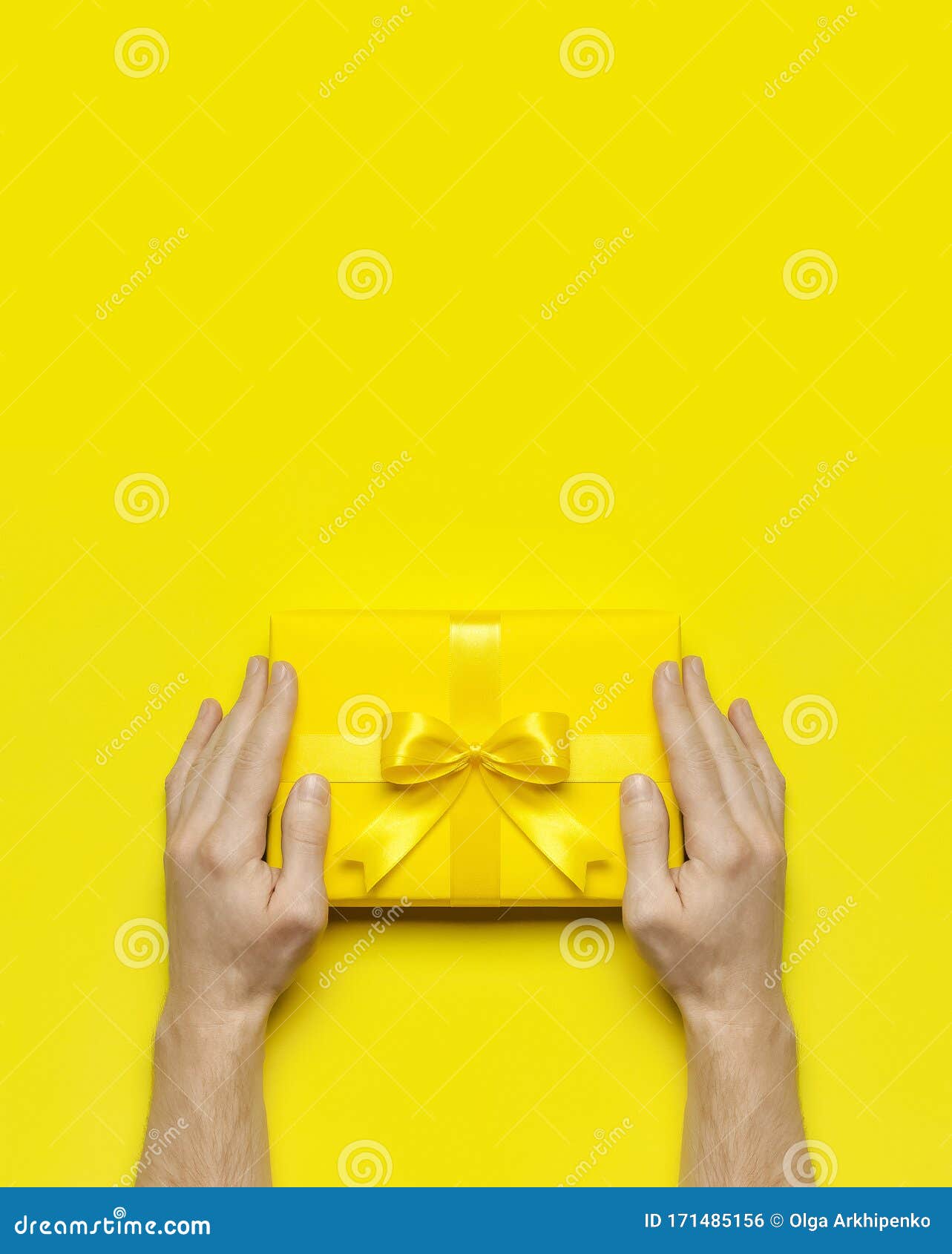 Male Hands Holding Bright Yellow Gift Present Box With