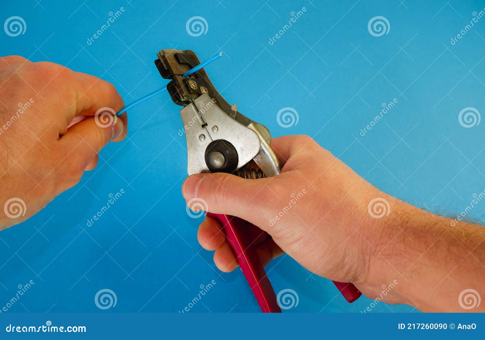 Male Hands with a Professional Tool Remove the Insulation from the
