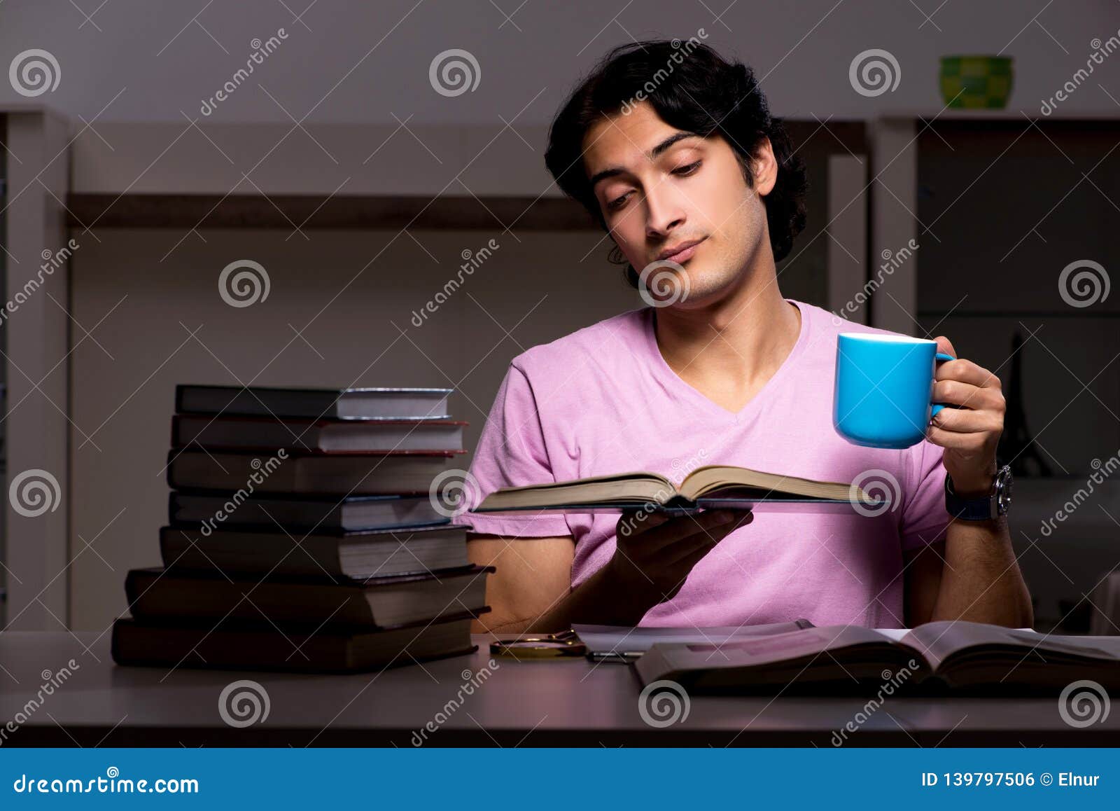 The Male Handsome Student Preparing for Exams Late at Home Stock Photo ...