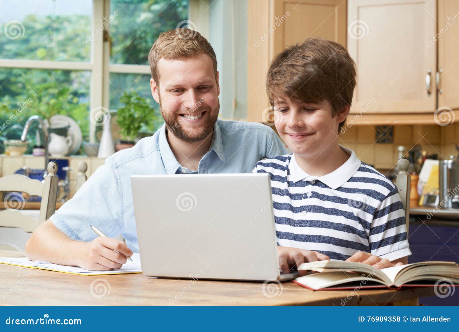 male home tutor helping boy with studies