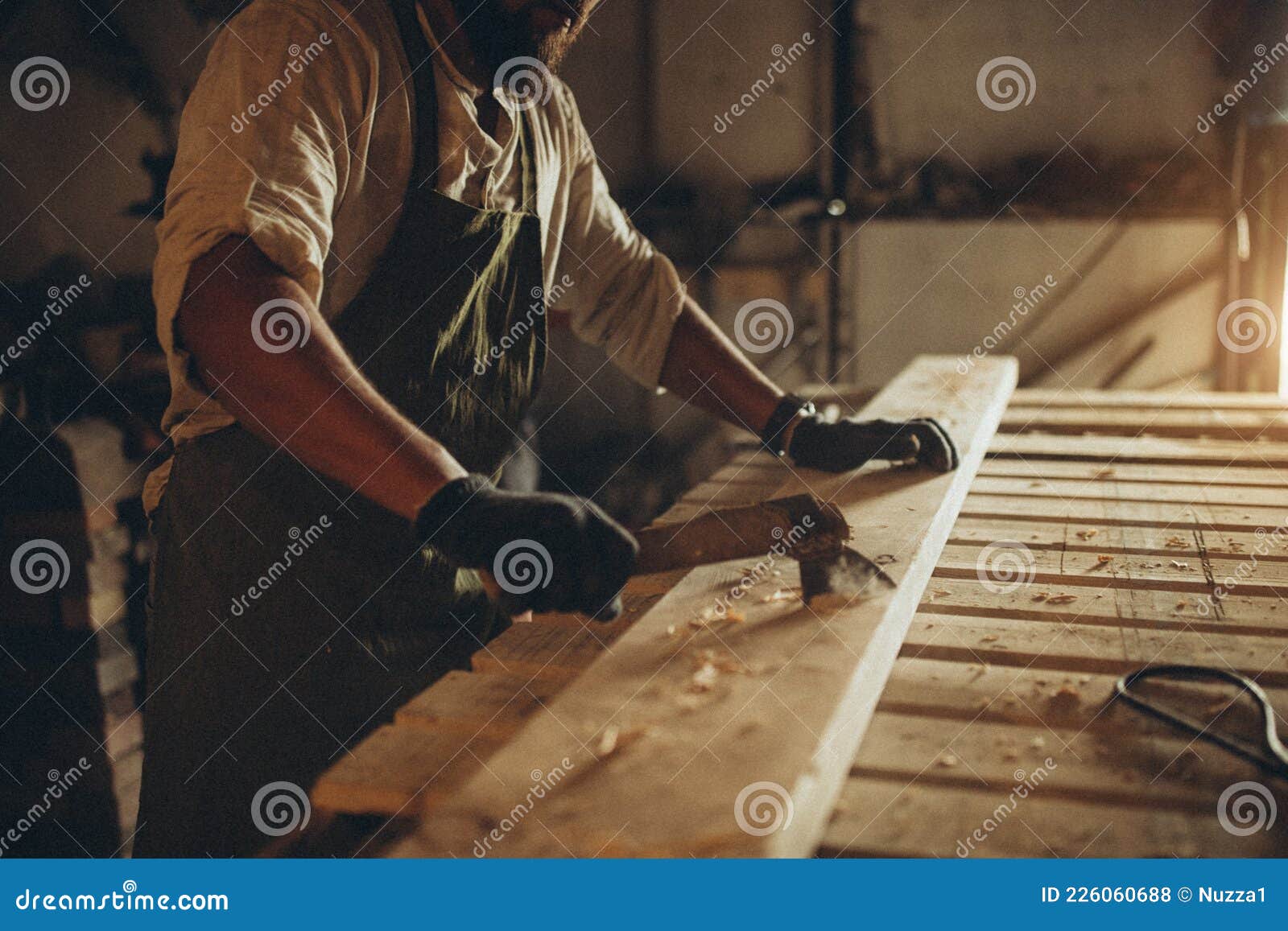 A Male Joiner Works With A Handheld Circular Saw. A Builder Is Sawing