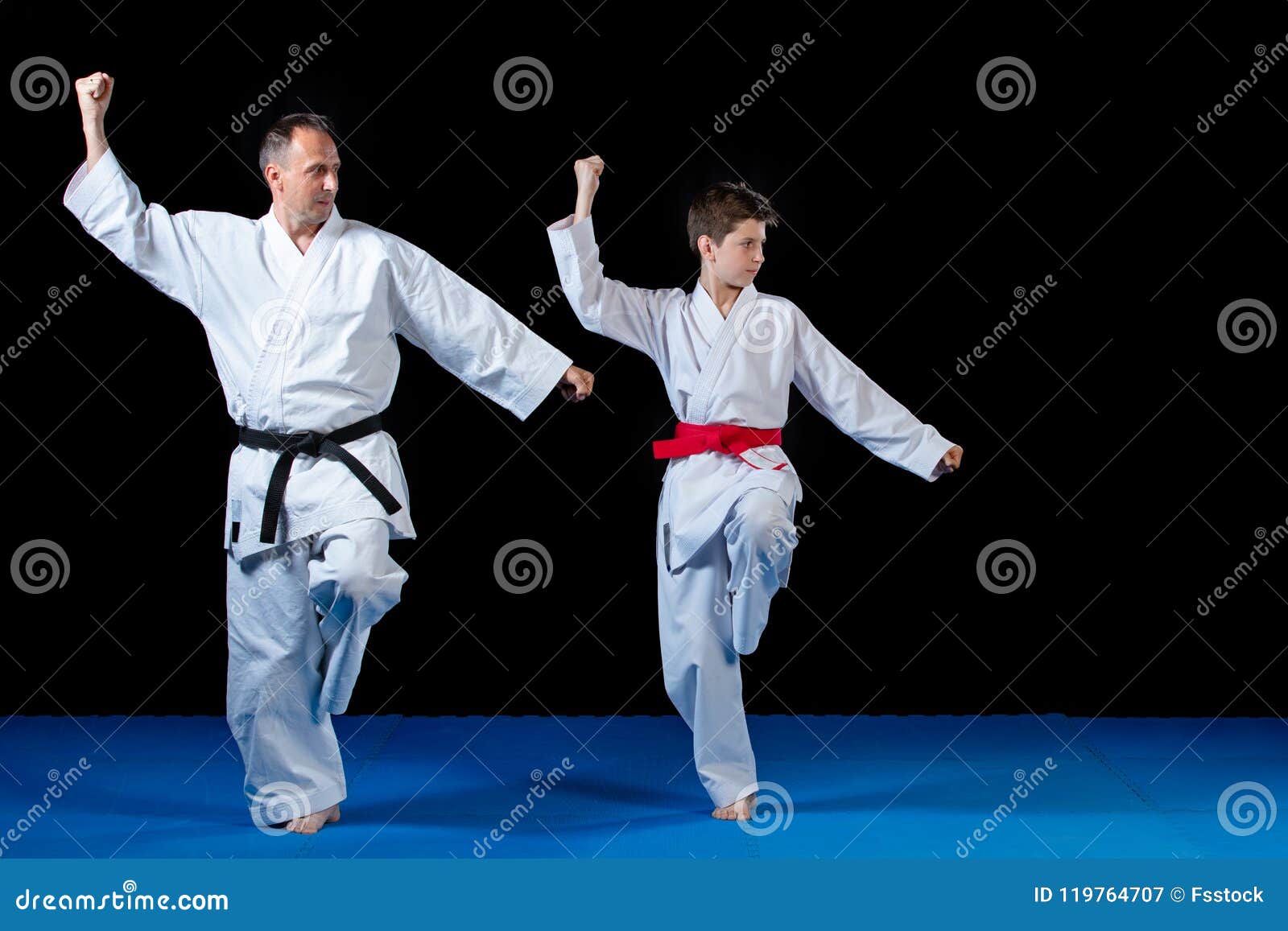 Male Karate Instructor Training Little Children in Dojo Stock Image
