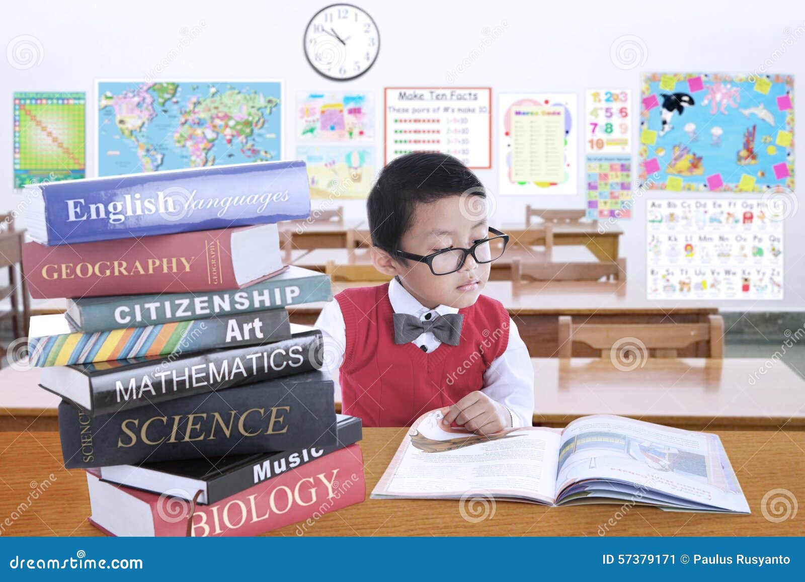 Male Kid Studying With Lesson Books In Class Stock Photo ...