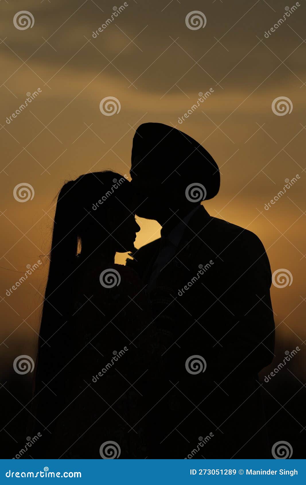 male kissing female on forehead.