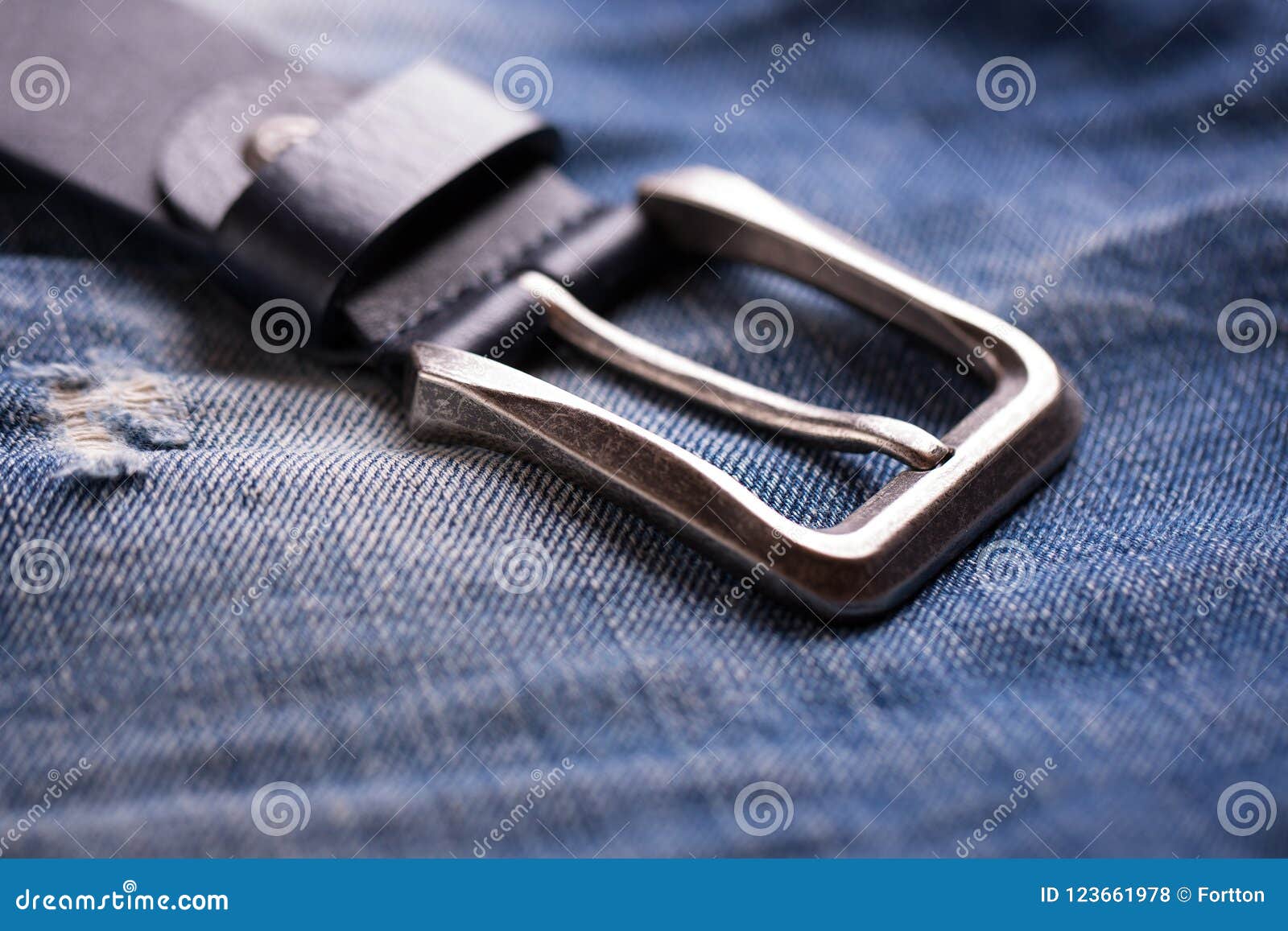 An Unbuttoned Belt Rests on a Denim Fabric Stock Photo - Image of close ...