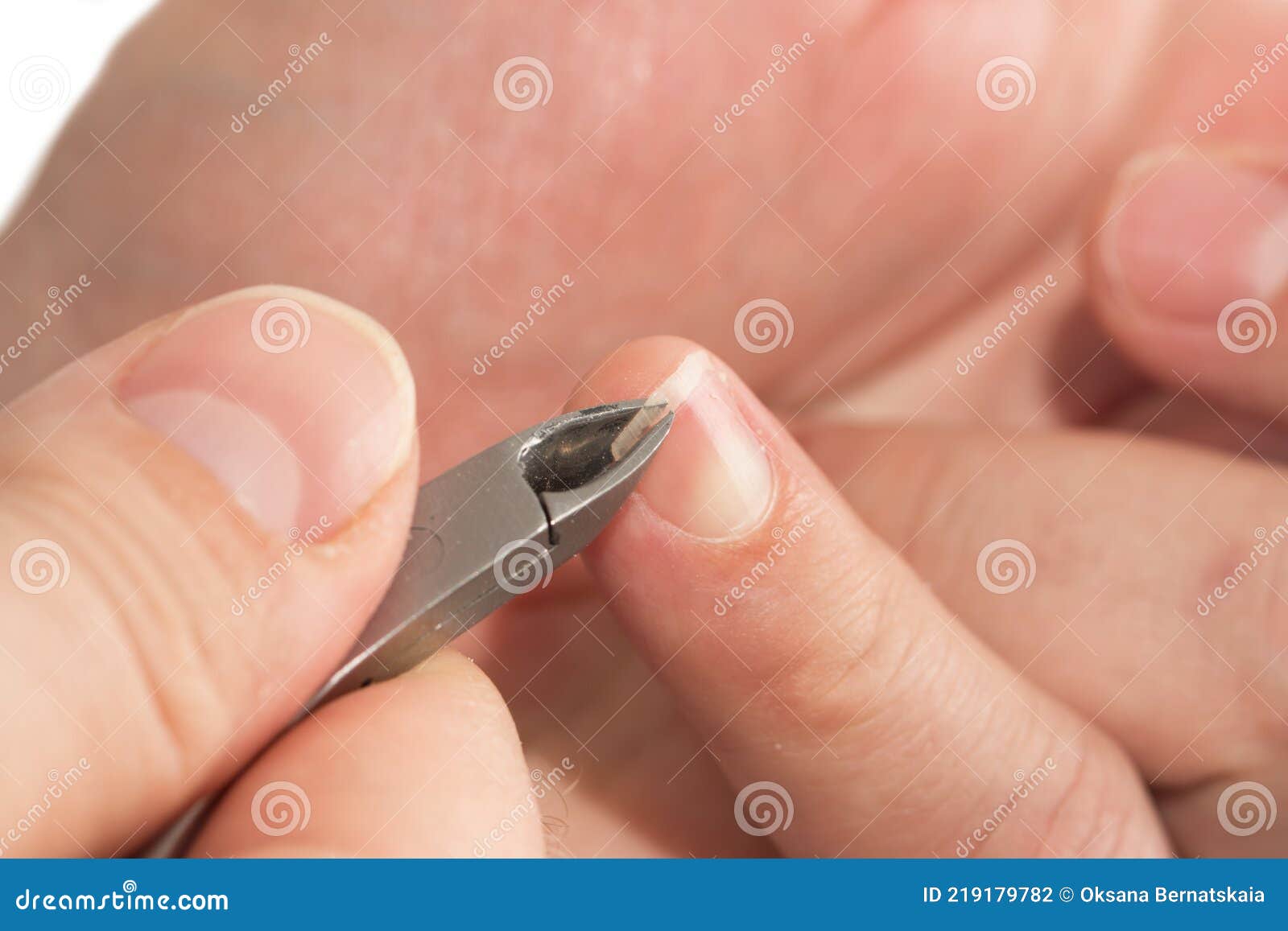 Male Manicure. Woman Hands In Blue Sterile Gloves Holding Male Finger