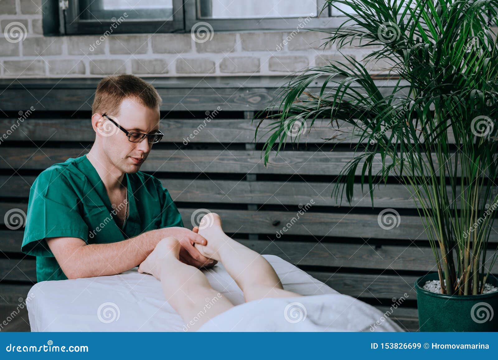 A Male Massage Therapist Massages The Feet And Legs Of Legs Stock Image Image Of Care