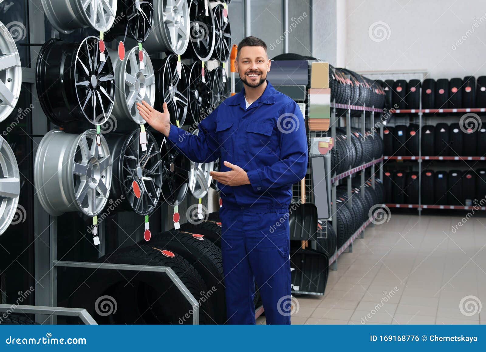 Male Mechanic Near Car Tires And Alloy Wheels Stock Photo Image of