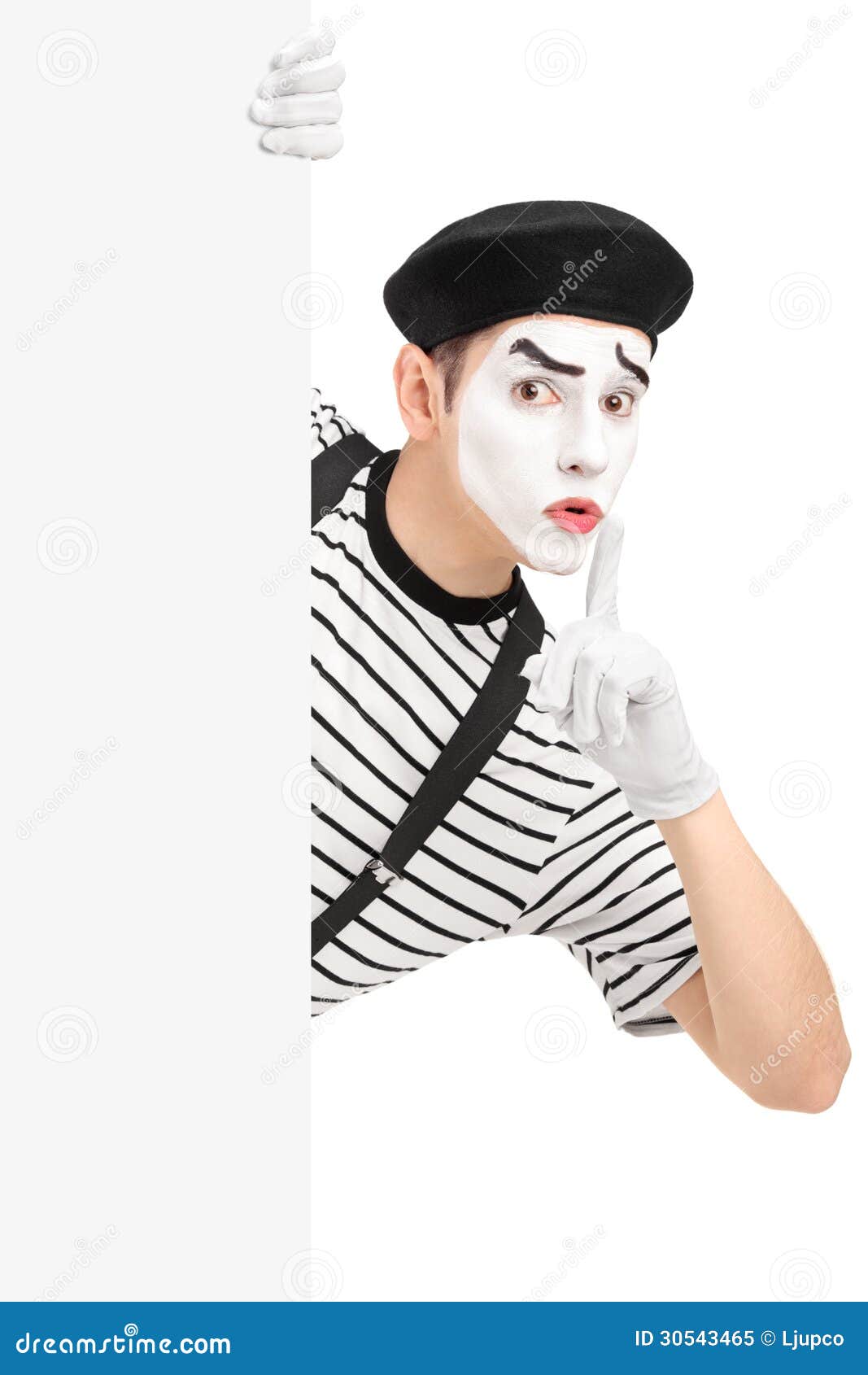 male mime artist holding blank panel gesturing silence wit finger his mouth isolated white background 30543465