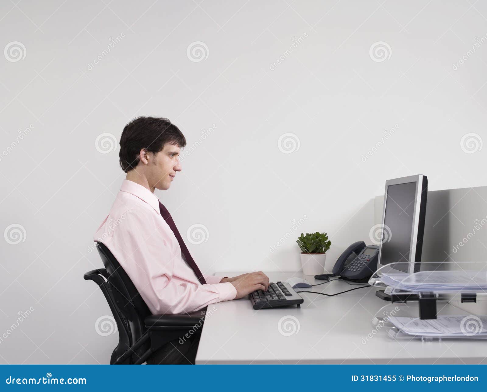 male office worker using computer desk side view 31831455