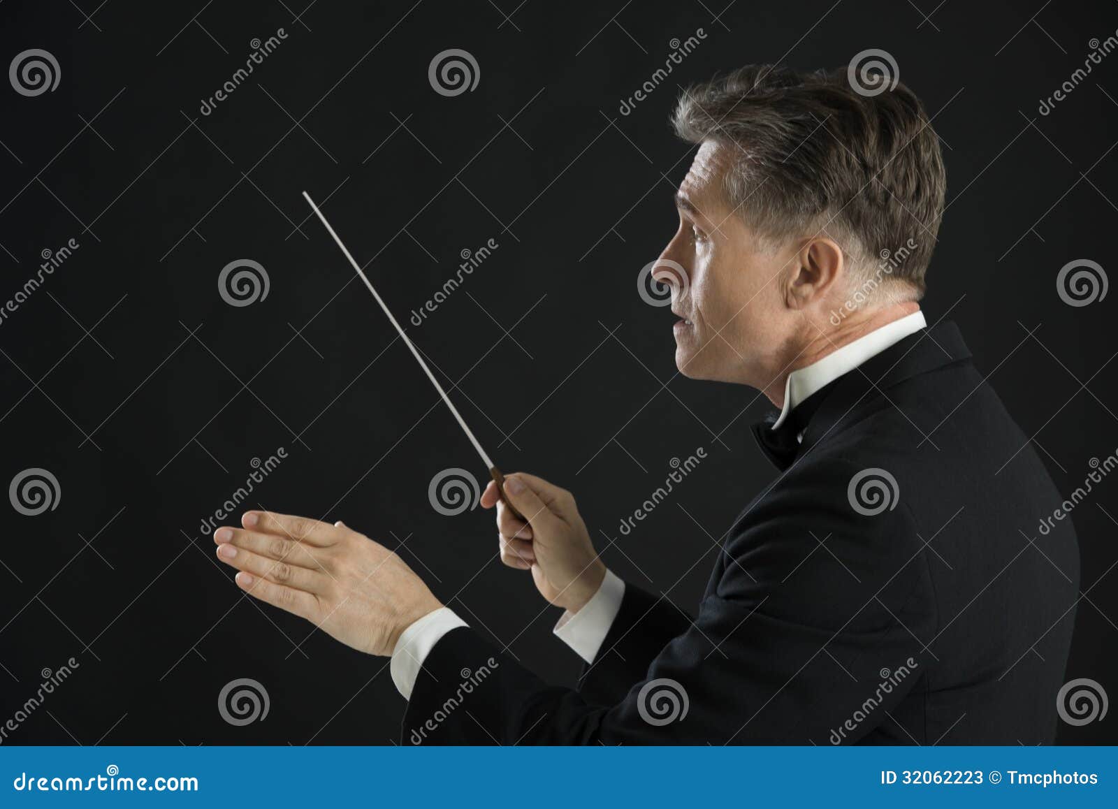 male orchestra conductor directing with his baton