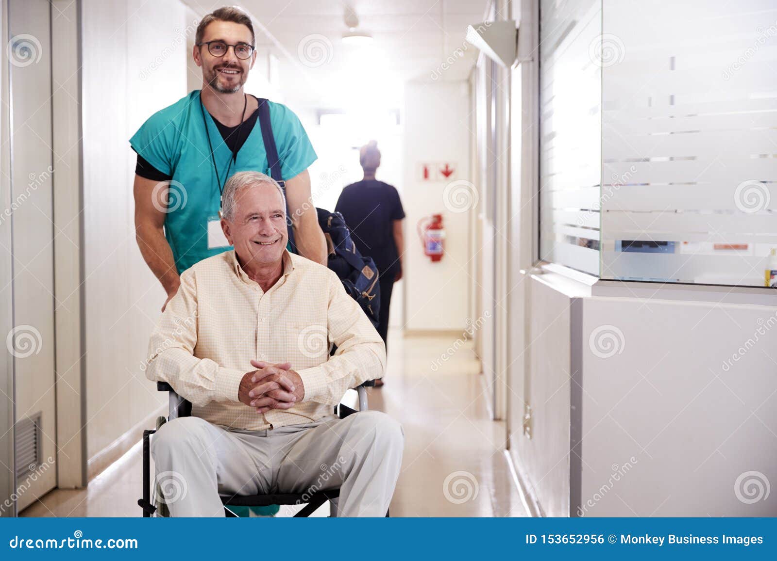 An Orderly Pushing A Little Girl In A Wheelchair Stock Image an-orderly-pushing-a-little-girl-in-a-wheelchair-stock-image
