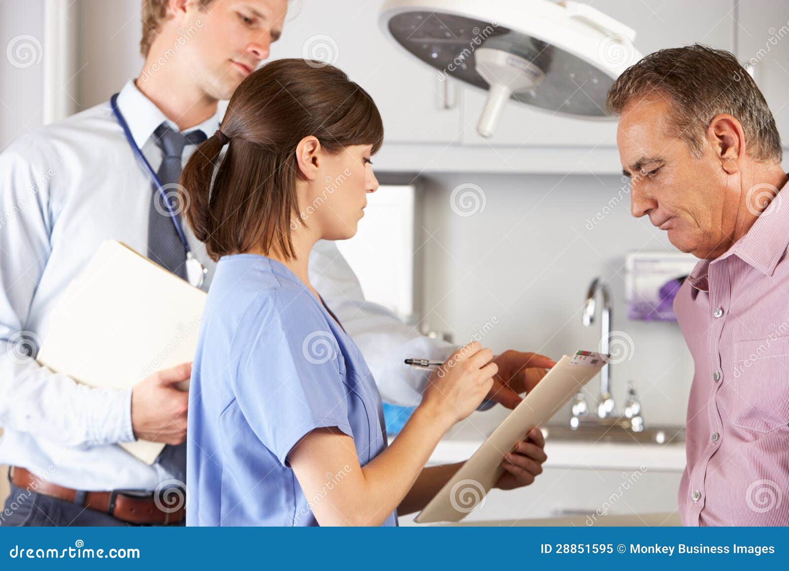 male patient being examined by doctor and intern