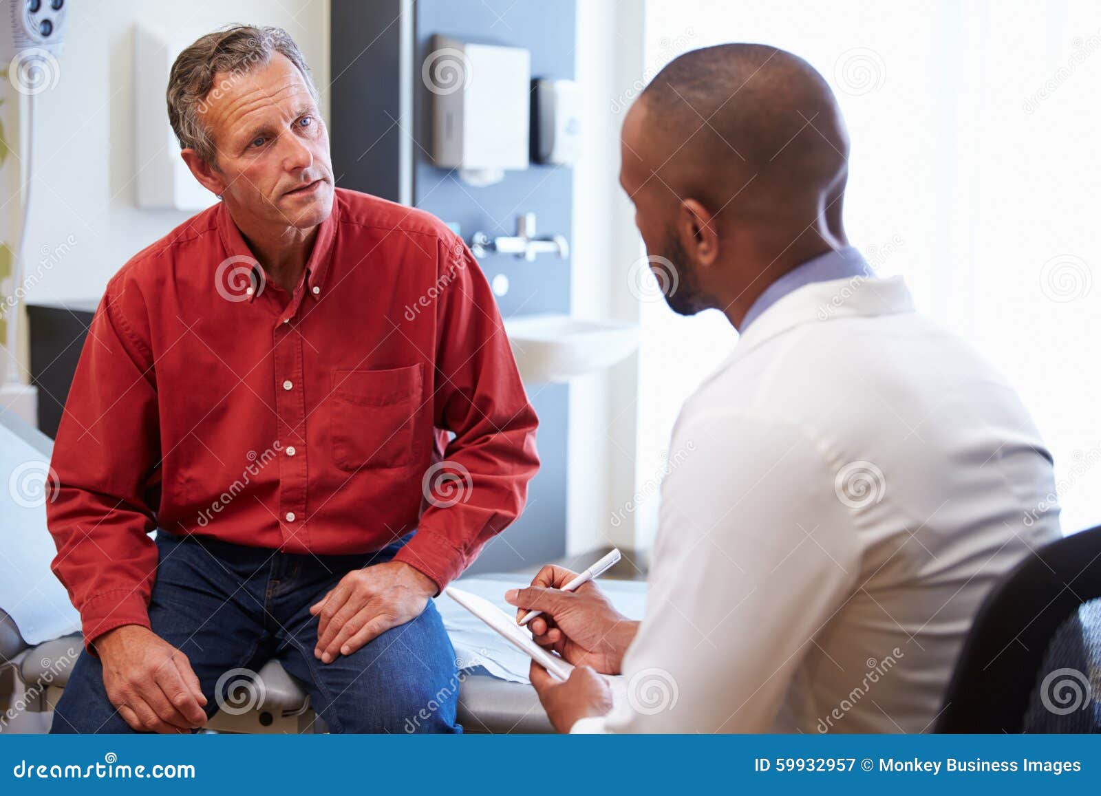 male patient and doctor have consultation in hospital room