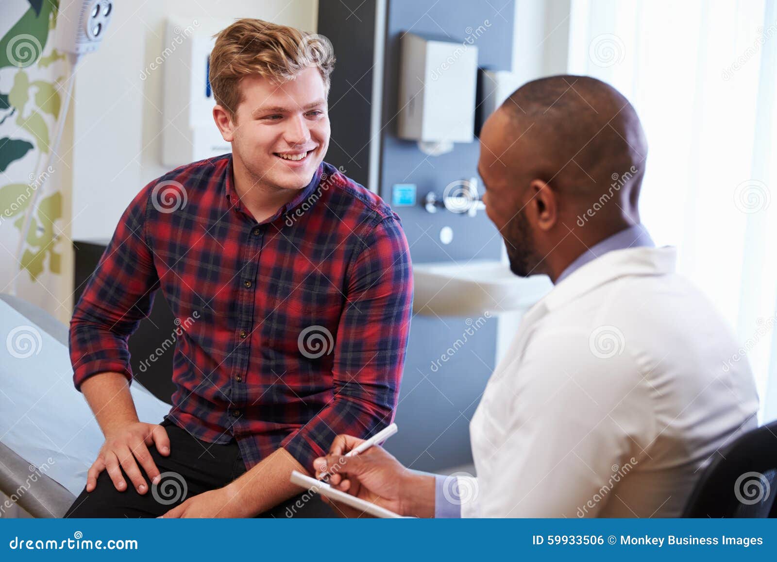 male patient and doctor have consultation in hospital room