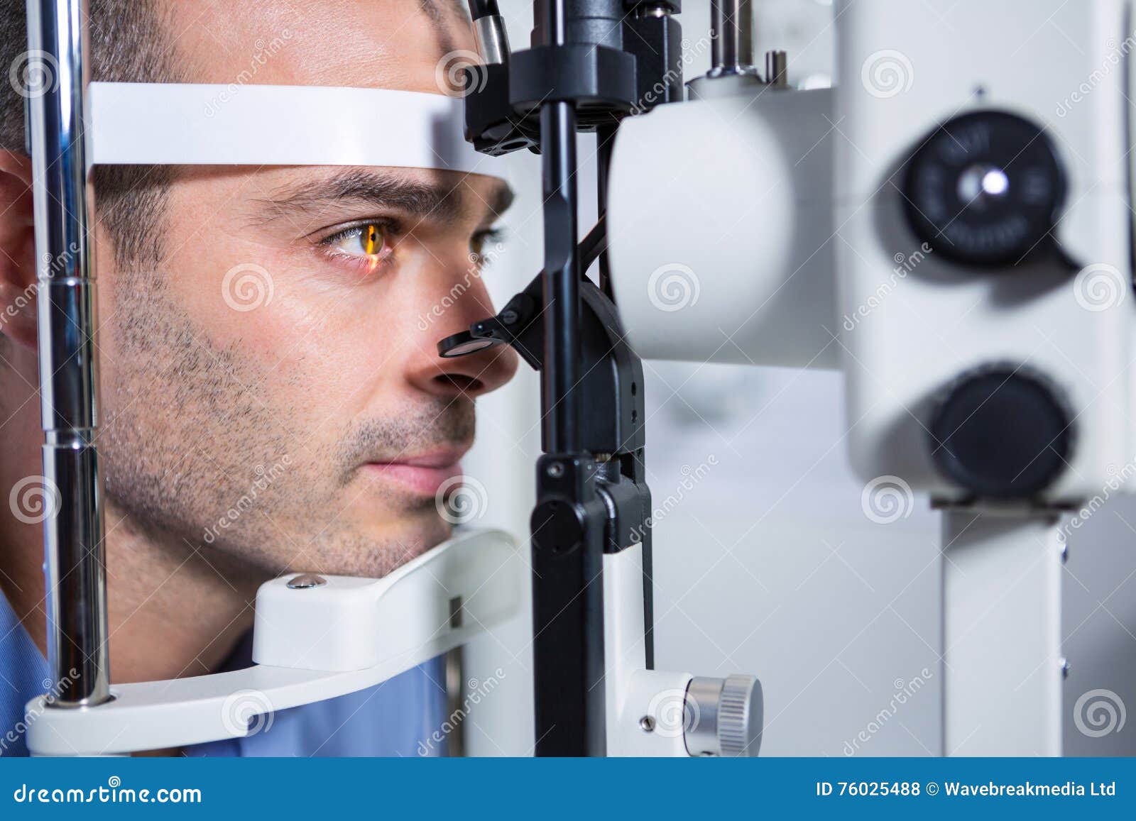 male patient getting his cornea checked with slit lamp